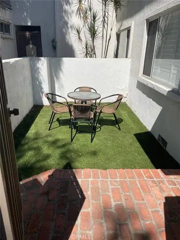 a backyard of a house with table and chairs