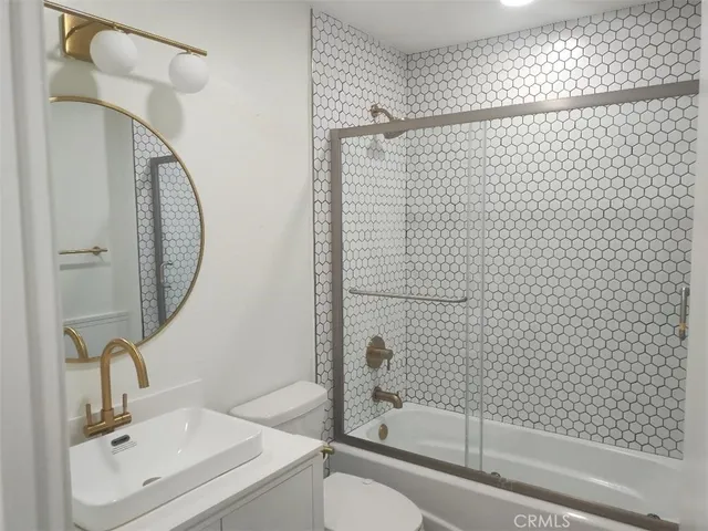 a bathroom with a sink a shower and a mirror