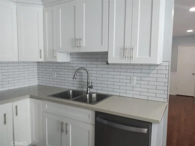 a kitchen with a sink and cabinets