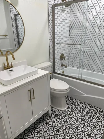 a bathroom with a toilet a sink and a mirror
