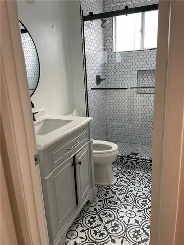 a bathroom with a sink toilet and shower