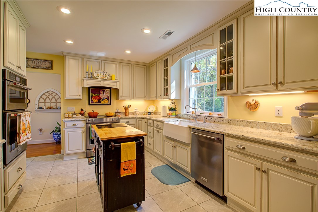 267 Vestal Road Sparta, NC 28675 - Photo 17 of 43 a kitchen with a sink stove and cabinets