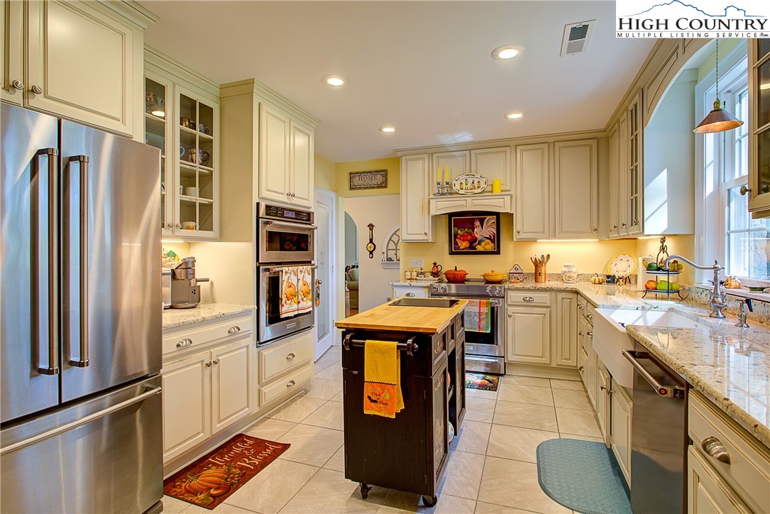 267 Vestal Road Sparta, NC 28675 - Photo 18 of 43 a kitchen with a refrigerator a stove top oven a sink and dishwasher