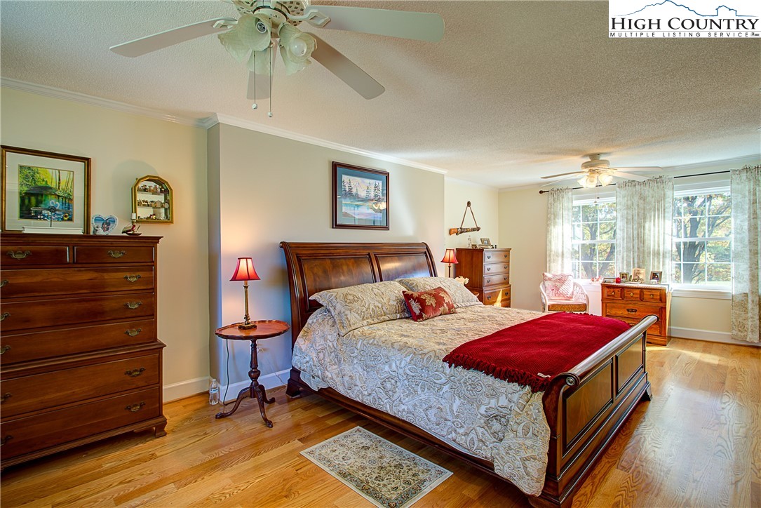 267 Vestal Road Sparta, NC 28675 - Photo 29 of 43 a bedroom with a bed and a chandelier