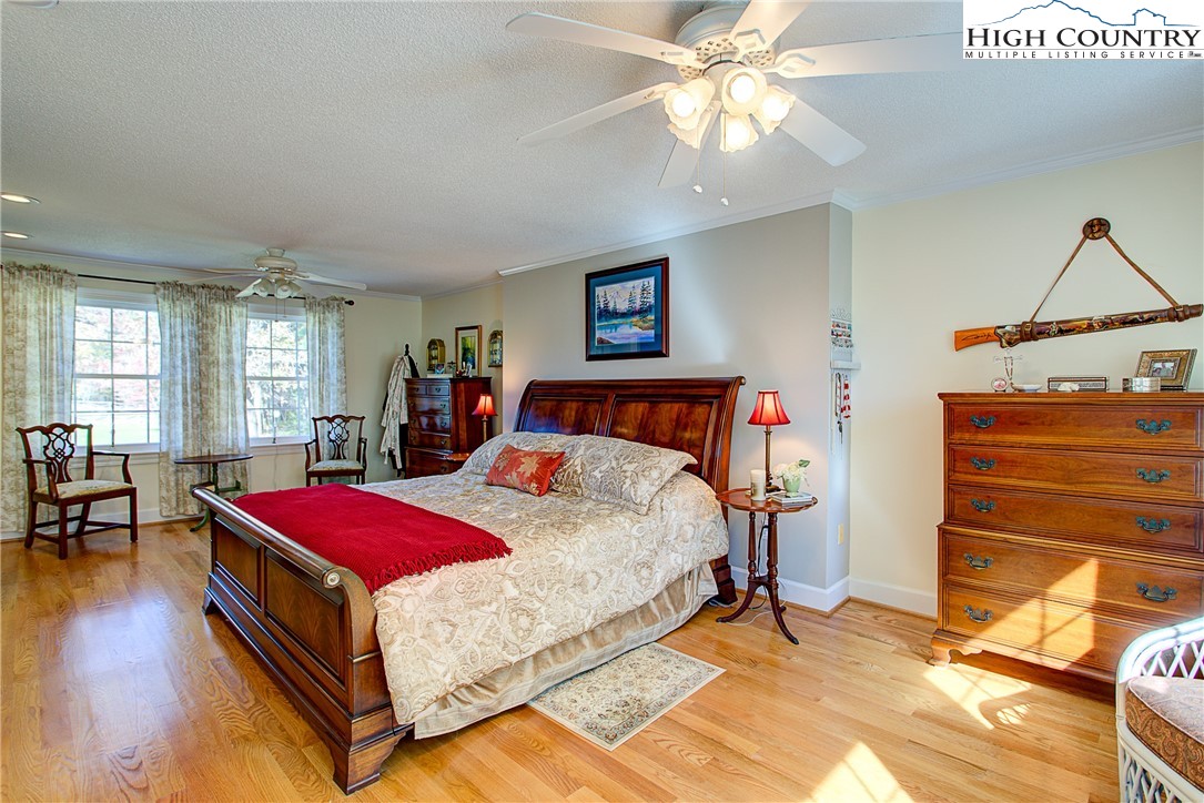 267 Vestal Road Sparta, NC 28675 - Photo 30 of 43 a bedroom with a bed and a chandelier