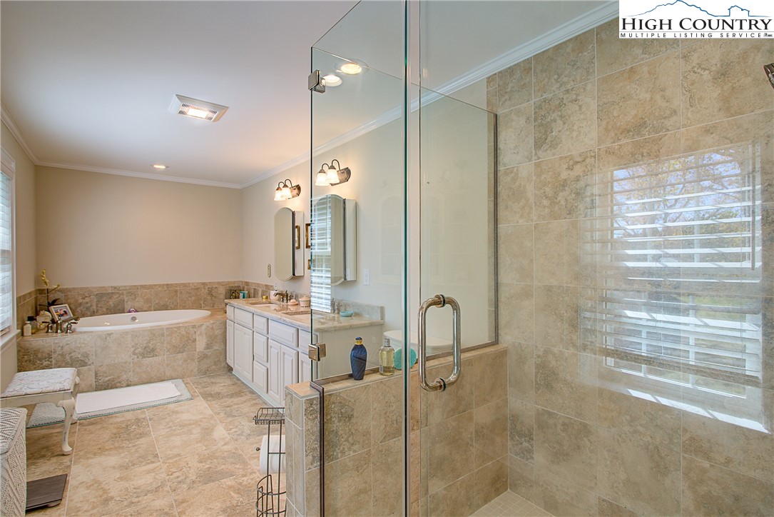 267 Vestal Road Sparta, NC 28675 - Photo 31 of 43 a bathroom with a tub a sink and mirrors