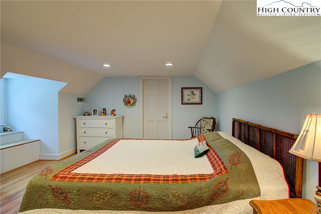 267 Vestal Road Sparta, NC 28675 - Photo 34 of 43 a bedroom with a bed and wooden floor