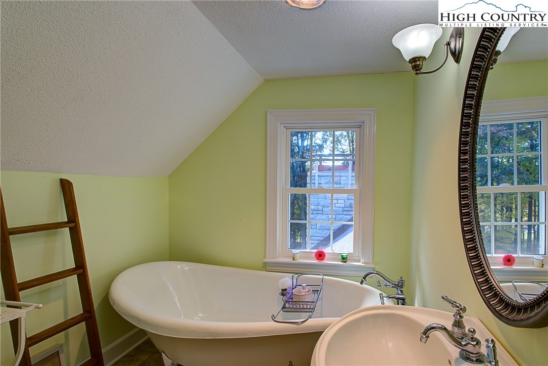267 Vestal Road Sparta, NC 28675 - Photo 38 of 43 a bathroom with a sink mirror and a bathtub
