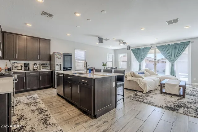 a kitchen with stainless steel appliances granite countertop a sink dishwasher stove and refrigerator