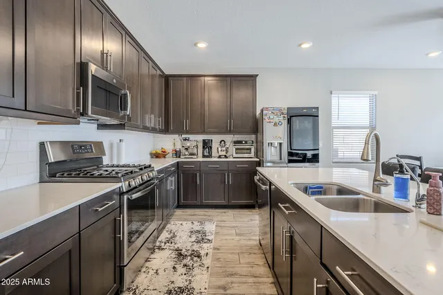 a kitchen with sink stove and view living room