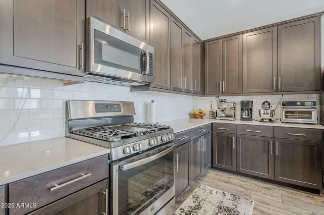 a view of a room with wooden floor and furniture