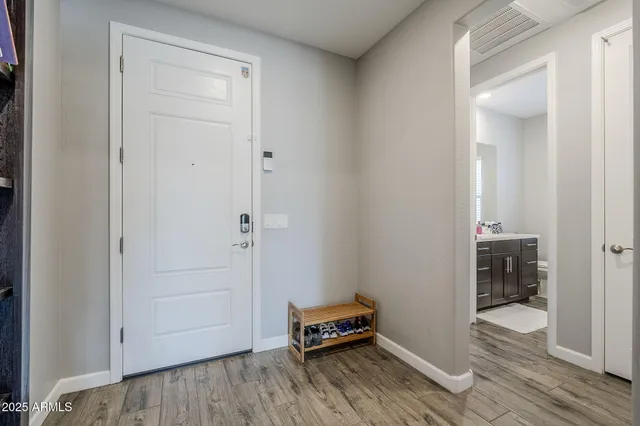 a bedroom with a bed and wooden floor