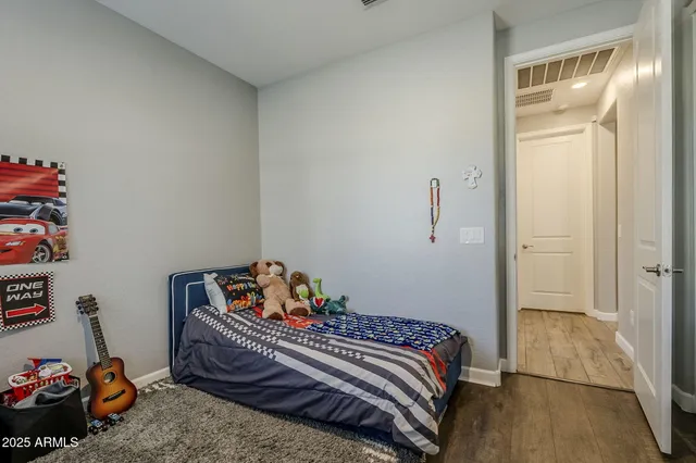 a spacious bedroom with a bed and a window
