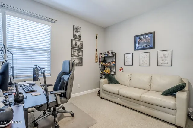 a view of a room that has a couch and a chandelier