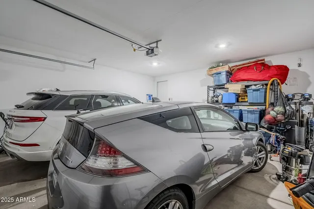 a view of a house with a small yard and large tree