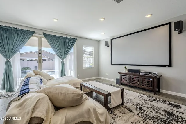 a bedroom with furniture and a flat screen tv