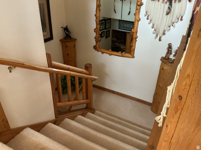 550 State Line Road Manila, UT 84046 - Photo 15 of 41 Staircase featuring wood-finish railings, wood-finish balusters, and carpeted treads