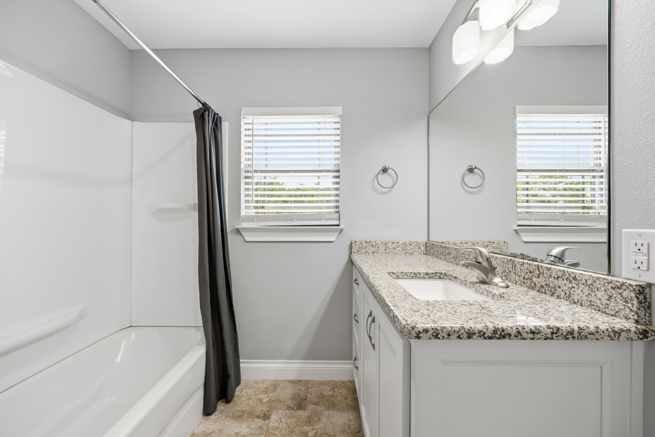 4105 Summit Hurst New Braunfels, TX 78132 - Photo 19 of 36 a bathroom with a granite countertop sink and a mirror