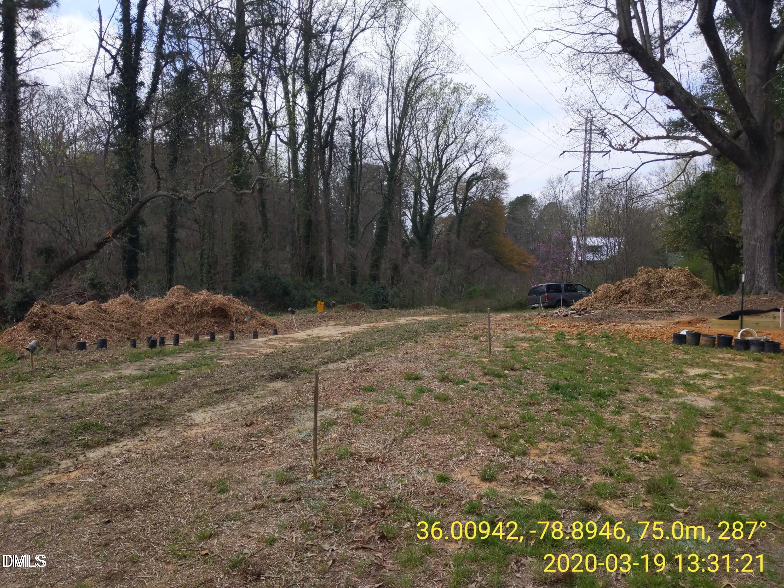 1313 Acadia Street Durham, NC 27701 - Photo 2 of 4 a backyard of a house with large trees