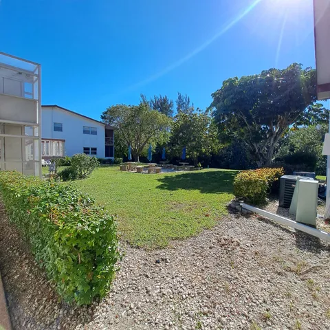 a view of a garden with a building in the background