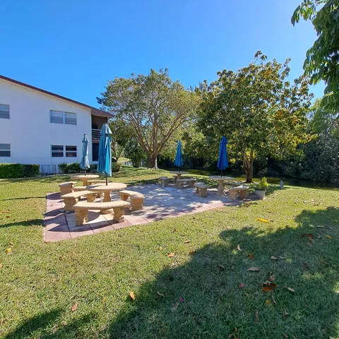 a swimming pool with outdoor view and trees