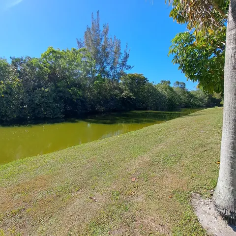 a view of outdoor space with swimming pool and green space