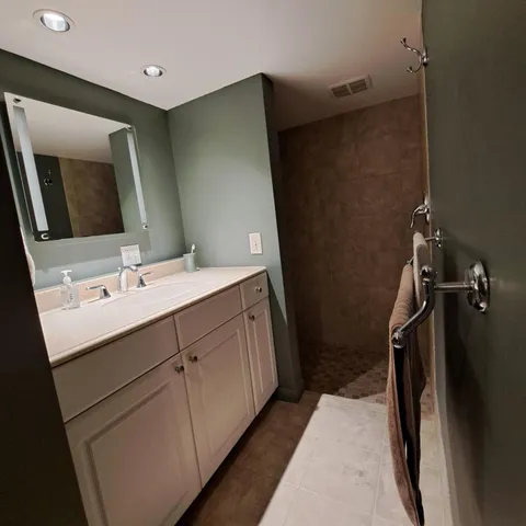 a bathroom with a double vanity sink a and mirror