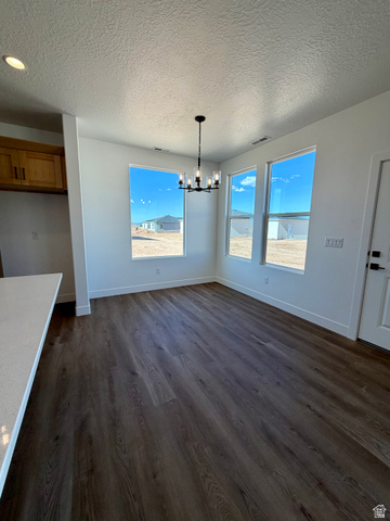 4956 North 925 East, Unit 87 Enoch, UT 84721 - Photo 7 of 19 Dining area featuring wood-finish flooring, three large windows, a contemporary black chandelier, and recessed lighting