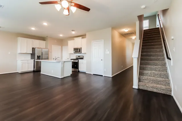 a view of a kitchen with wooden floor and electronic appliances