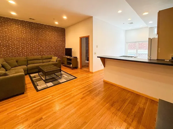 a living room with hard wood floors and a table