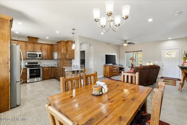 a large kitchen with a table and chairs
