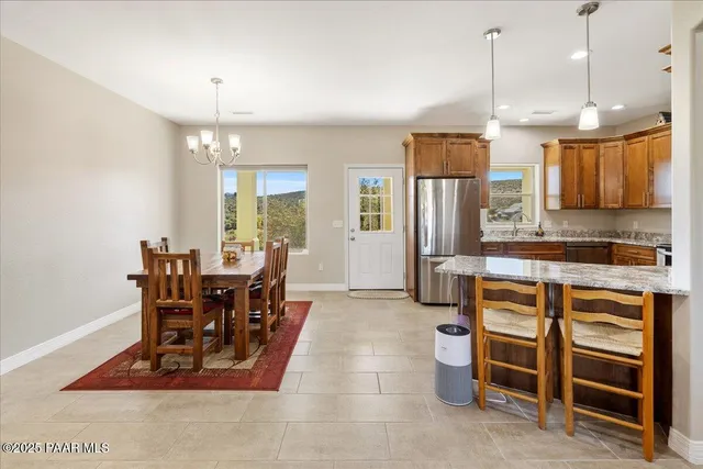 a view of a kitchen with dining room and wooden shelves