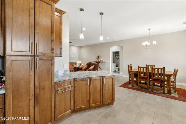 a kitchen with stainless steel appliances a refrigerator and a view of living room