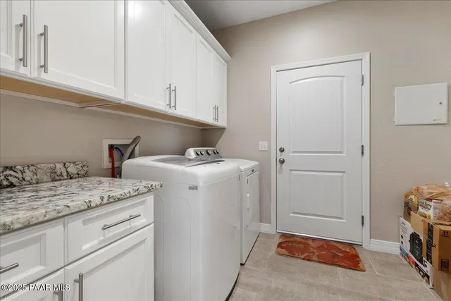 a utility room with sink dryer and washer
