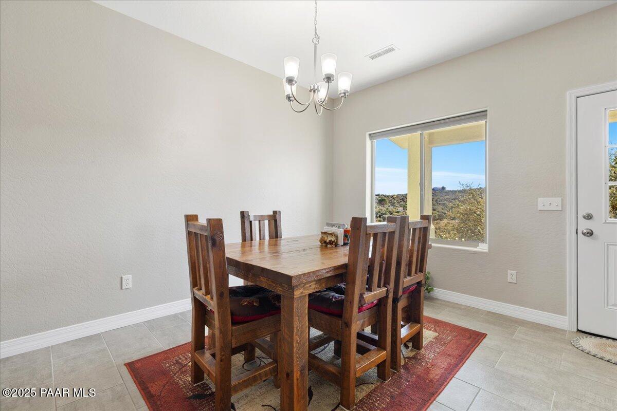 12376 East Prescott Dells Road Dewey-Humboldt, AZ 86327 - Photo 9 of 30 a view of a dining room with furniture window and outside view