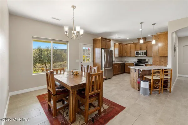 a view of a dining room with furniture and a chandelier
