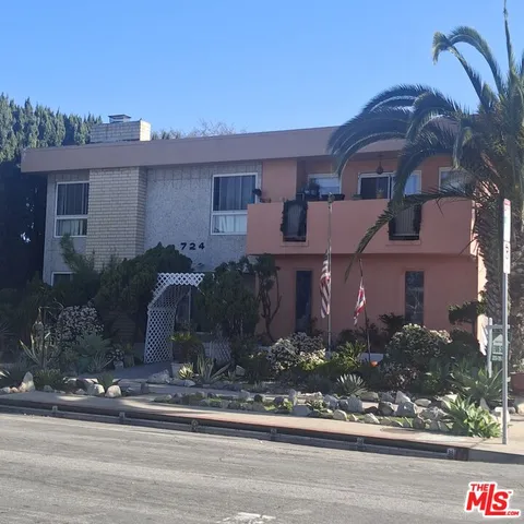 a front view of a house with a yard and a garage