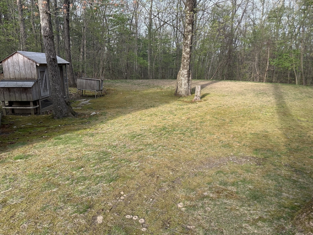 124 Cooper Road Northbridge, MA 01534 - Photo 24 of 25 a backyard of a house with table and chairs