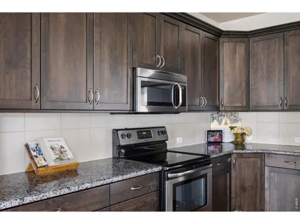 a kitchen with stainless steel appliances wooden cabinets and a sink