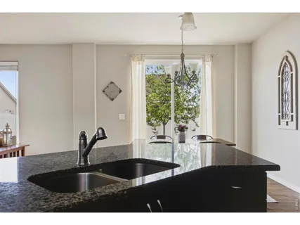 a kitchen with a sink and large window