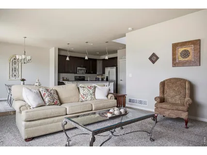 a living room with furniture and kitchen view