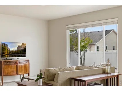 a living room with a flat screen tv and a large window