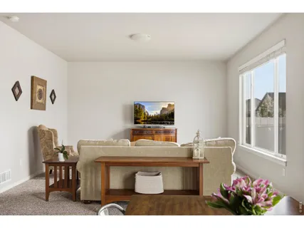 a living room with a table and a chair