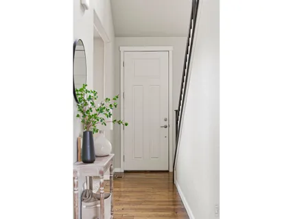a hallway with two couches and a potted plant