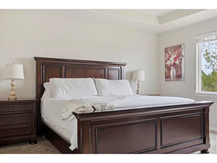 a bedroom with a bed and a night stand