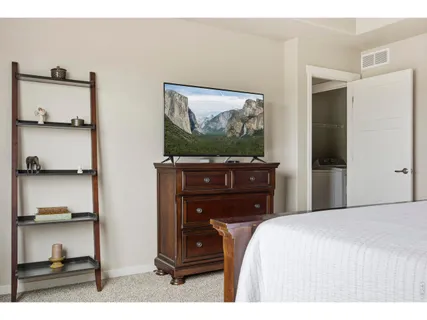 a bedroom with a bed and a television