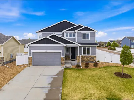a front view of a house with yard and garage