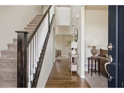 a view of entryway and hall with wooden floor