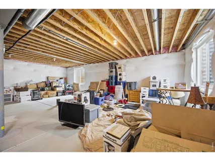 a living room with lots of furniture and clutter