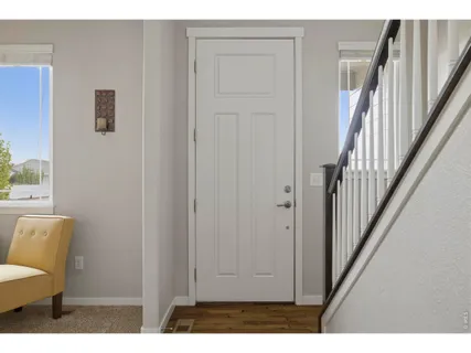 a view of a livingroom with furniture and stairs